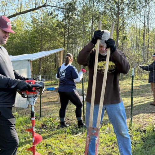 Helping Hands volunteers from Intrepid, an SPA Company, rolled up their sleeves and got to work at Next Step Farms.