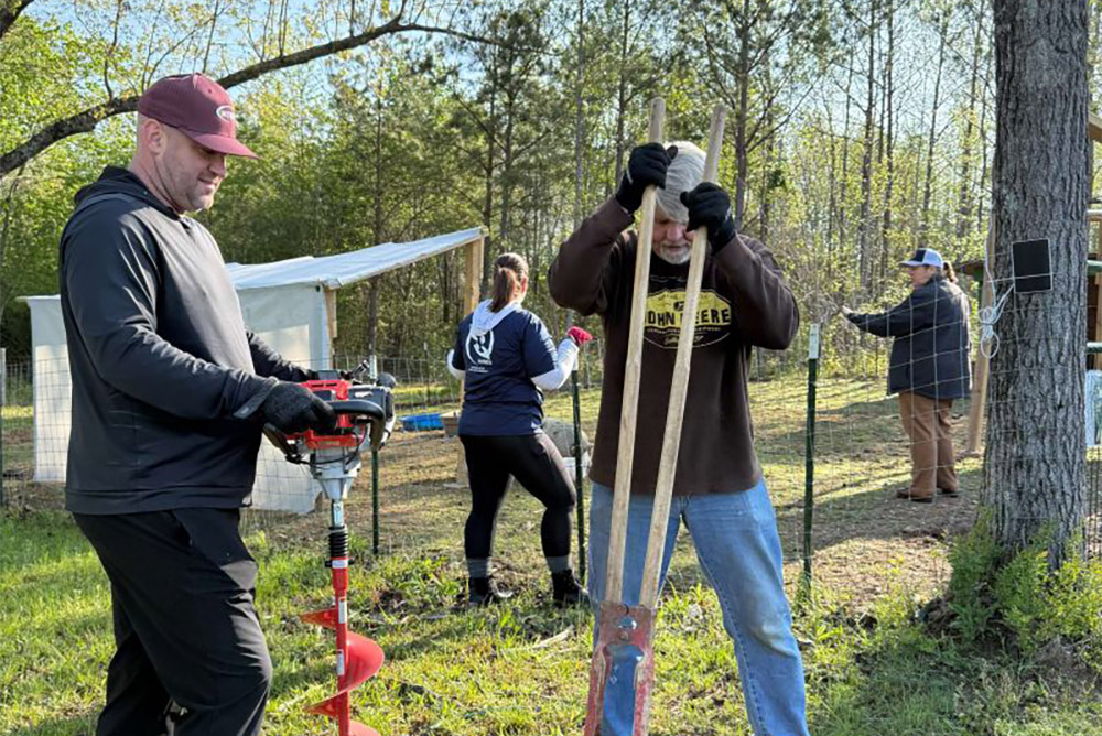 Helping Hands volunteers from Intrepid, an SPA Company, rolled up their sleeves and got to work at Next Step Farms.
