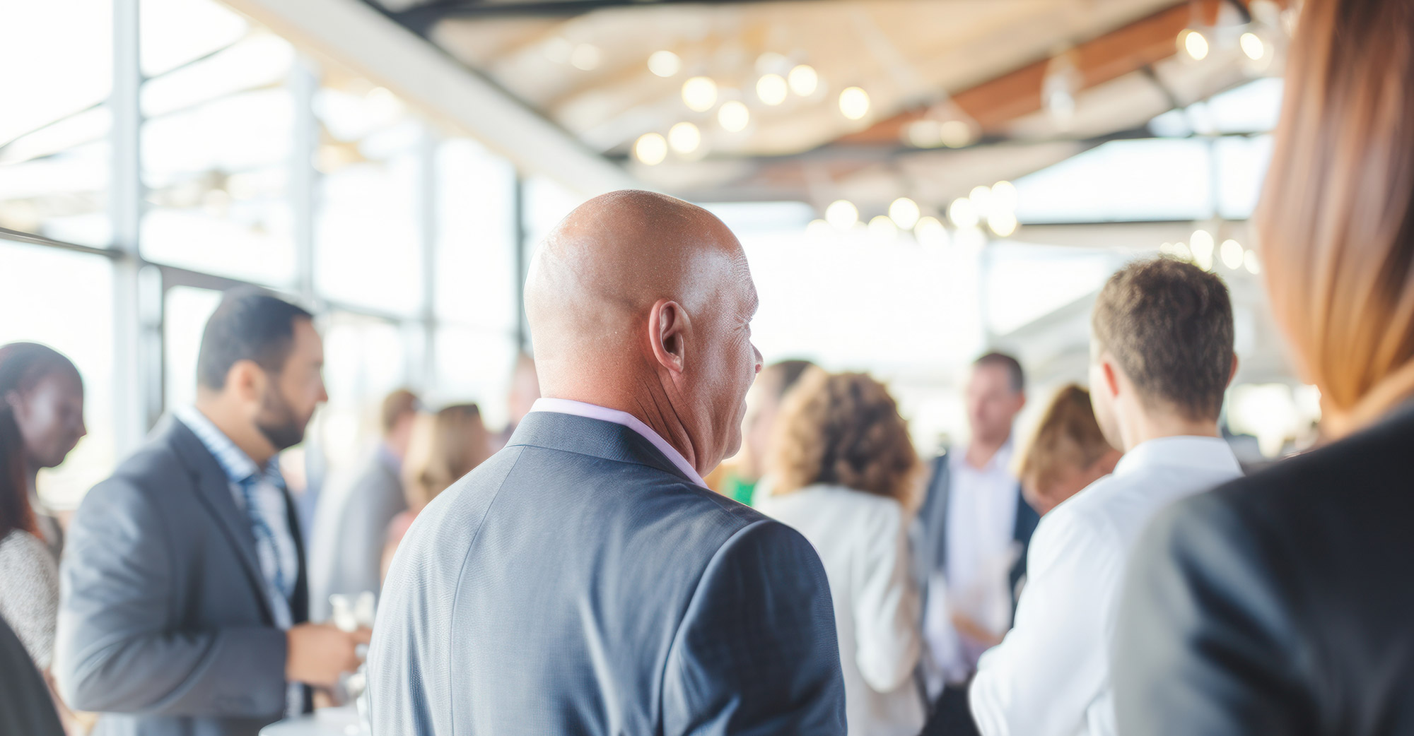 A stock image of a room full of people networking