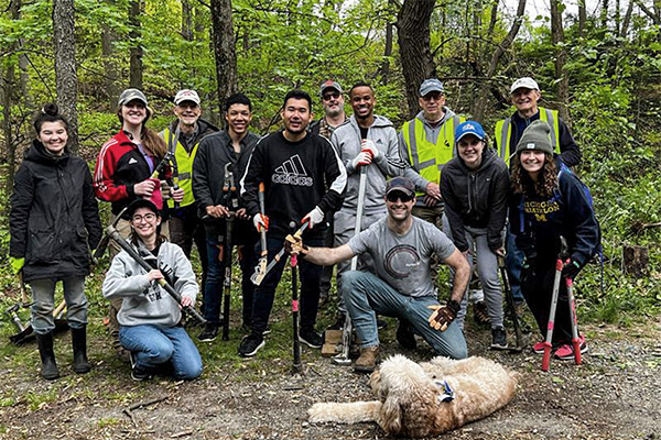 A group of SPA employees clean up invasive plant species from Glencarlyn Park in Arlington, VA